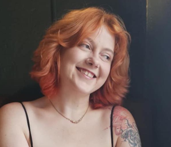Em, UX designer with red hair